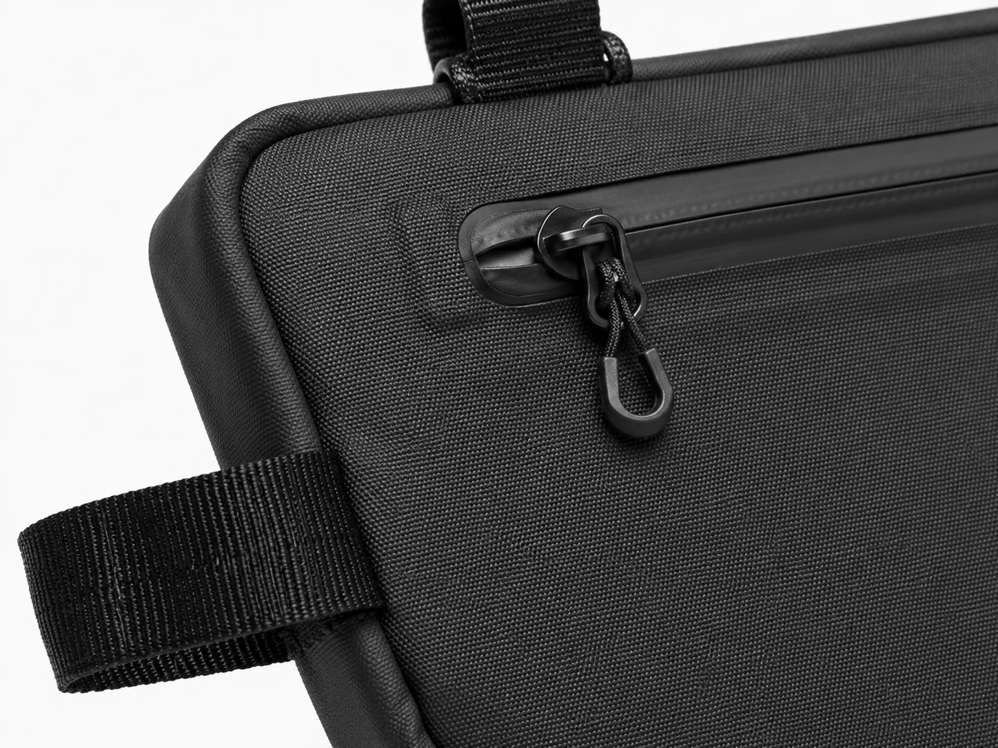 Close-up of waterproof cycling frame bag zipper, fabric and mounting strap