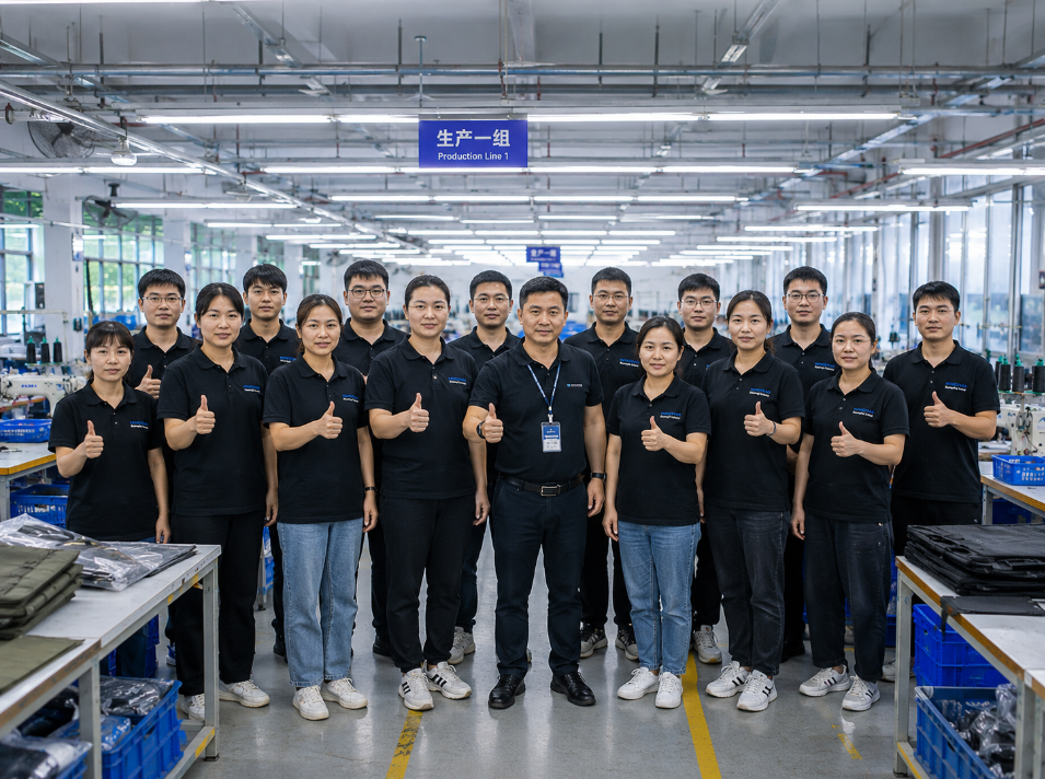 Outdoor bag production team standing in front of sewing production lines