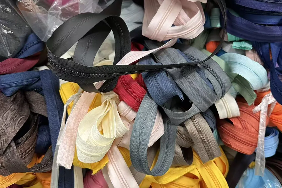 Backpack zipper color samples checked against fabric and logo requirements