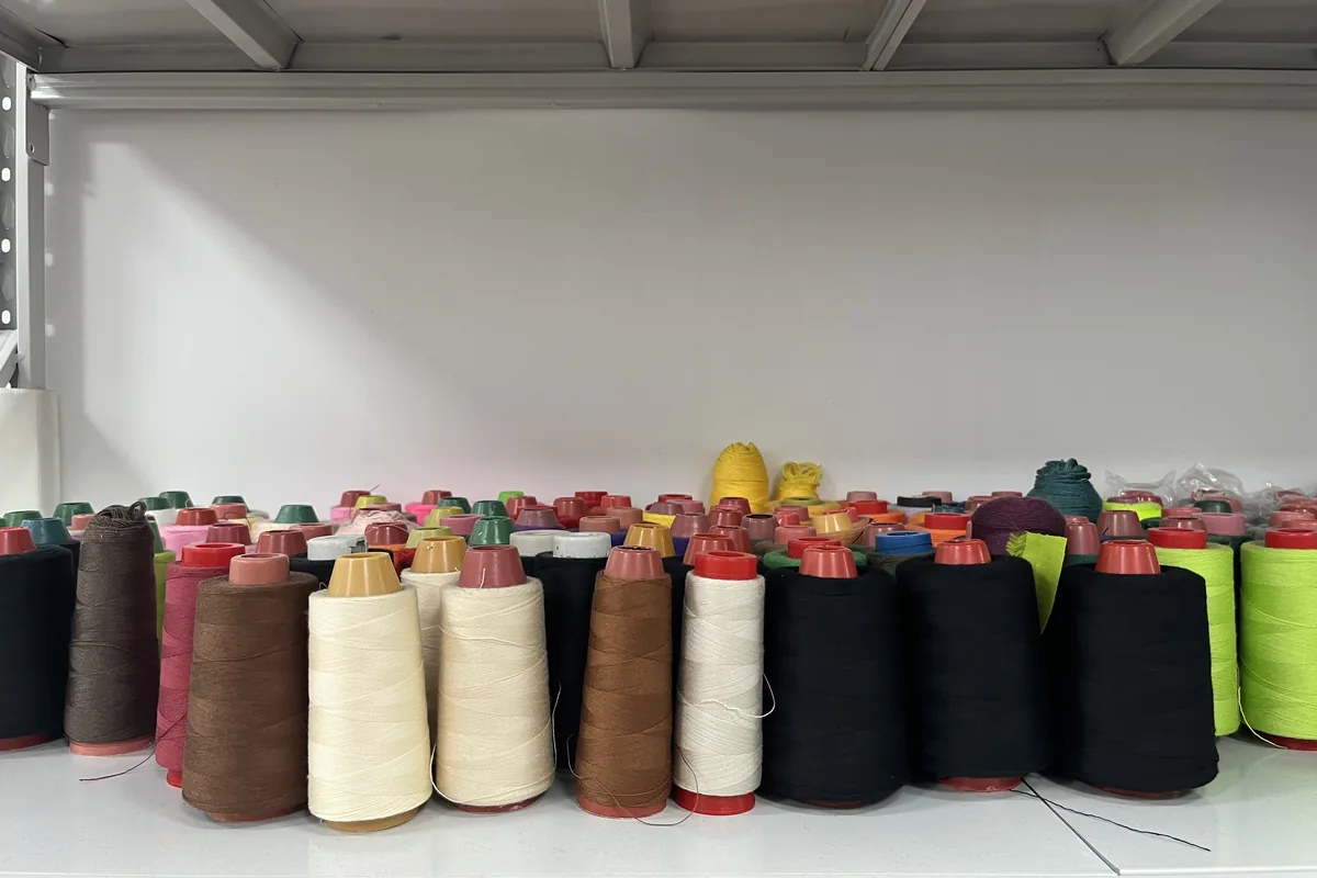 Sewing thread colors selected to match backpack fabric and visible stitching