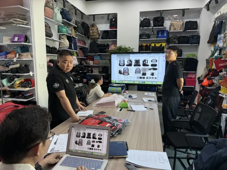 Hongzhao team reviewing a customer hiking backpack design drawing before OEM sampling