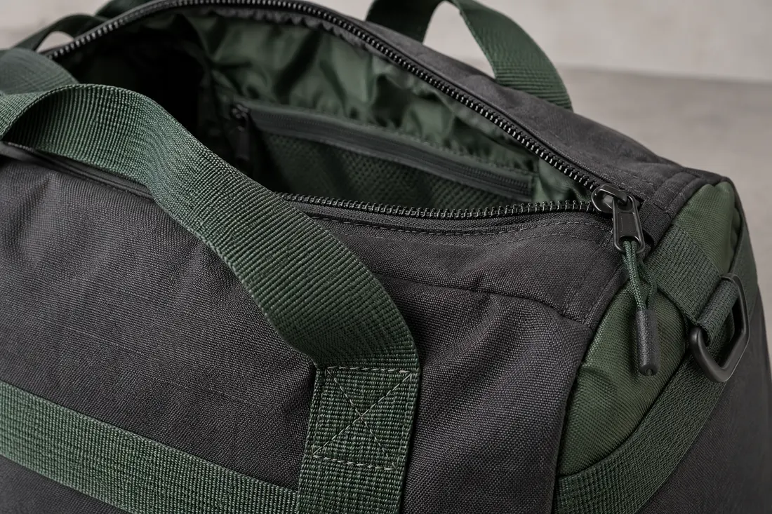 Concept close-up of duffel top zipper, lining and carry-handle attachment for sample access checks