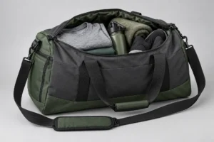 Concept sports duffel opened with folded training clothes, shoes and a bottle for a buyer packing review